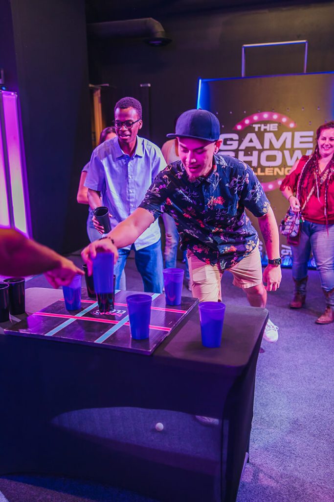 A competitive man wearing a hat at the Game Show Challenge